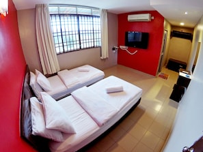 A hotel room with two beds, a TV, an air conditioner, and a bathroom visible through a door. - JV Hotel Simpang Ampat (Simpang Ampat)