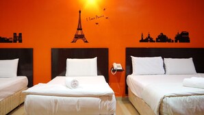 A hotel room with two beds, a wall-mounted phone, and a mural of Paris landmarks.