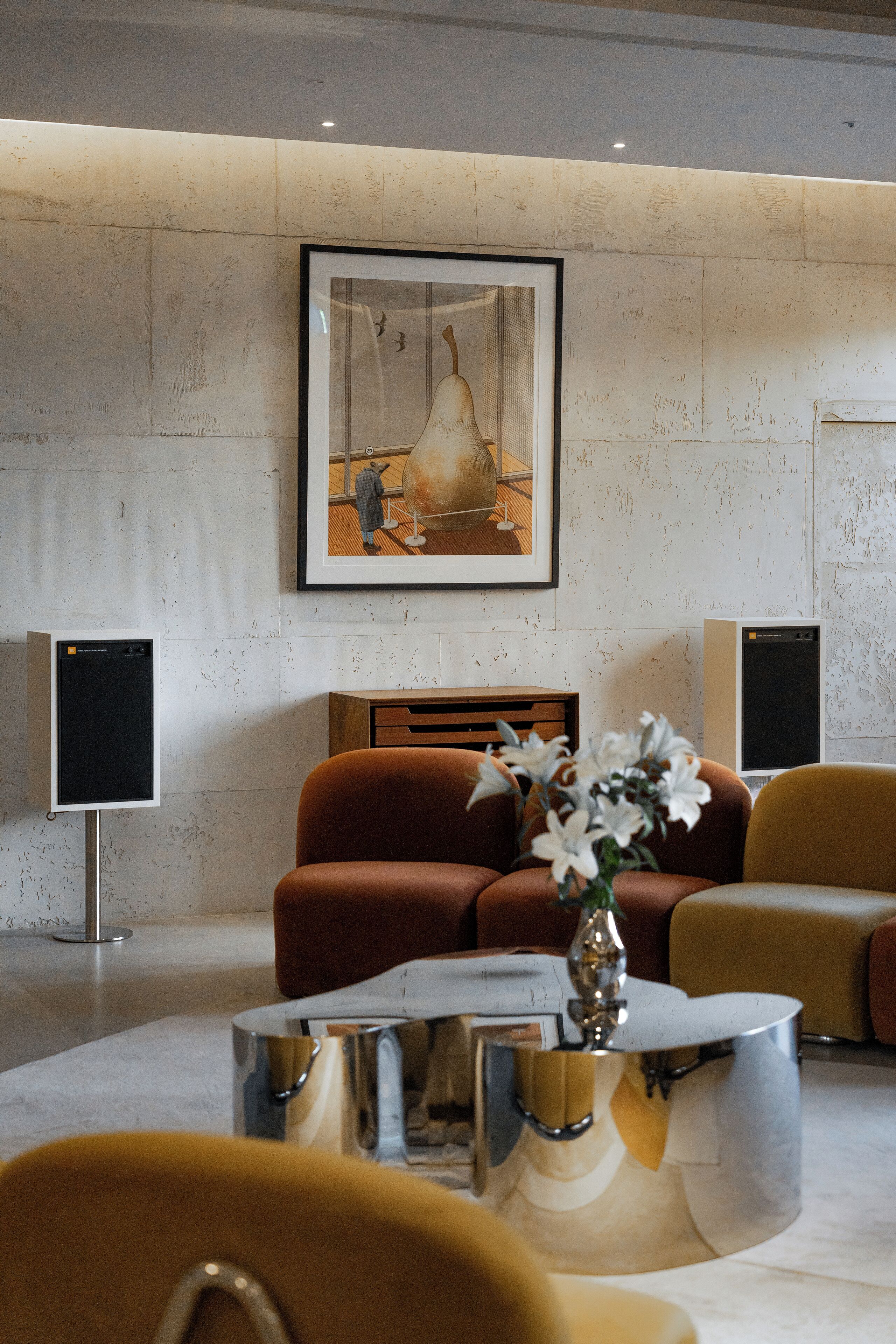 A modern living room with a sofa, a coffee table, and a framed artwork on the wall.
