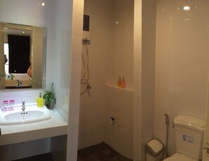 A bathroom with a sink, mirror, shower, and toilet. - Glitter House (Karon)