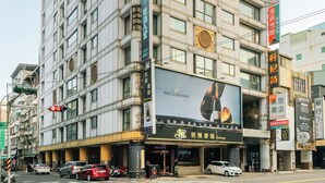A multi-story hotel with a prominent sign for "Moet & Chandon" on the facade.