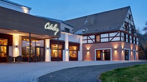 Un hôtel doté d’une façade moderne, de grandes fenêtres et d’une entrée bien éclairée.