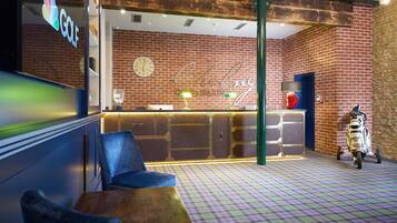 A bar area with a checkered floor, a scooter, and a neon sign.