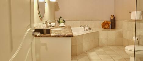 A bathroom with a bathtub, toilet, and sink.