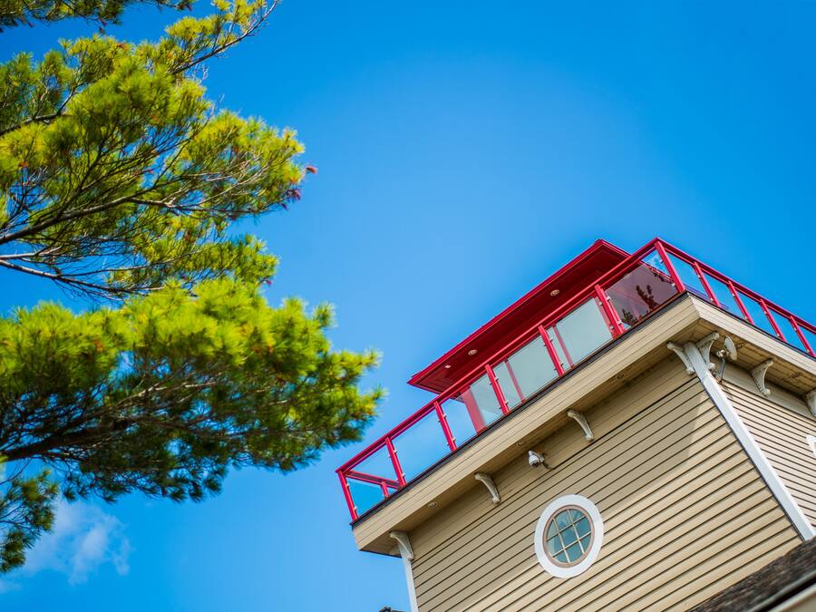 A building with a red balcony and a round window.