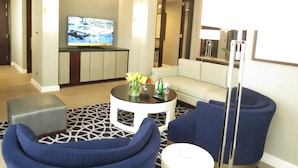 A modern living room with a sofa, armchairs, a coffee table, and a flat-screen TV. - Jabal Omar Hyatt Regency Makkah (Makkah)