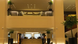 A spacious lobby with a polished floor, a staircase leading to the upper level, and potted plants. - Jabal Omar Hyatt Regency Makkah (Makkah)