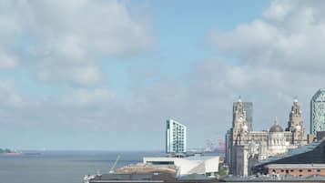 A cityscape with a prominent clock tower, historic buildings, and modern architecture.