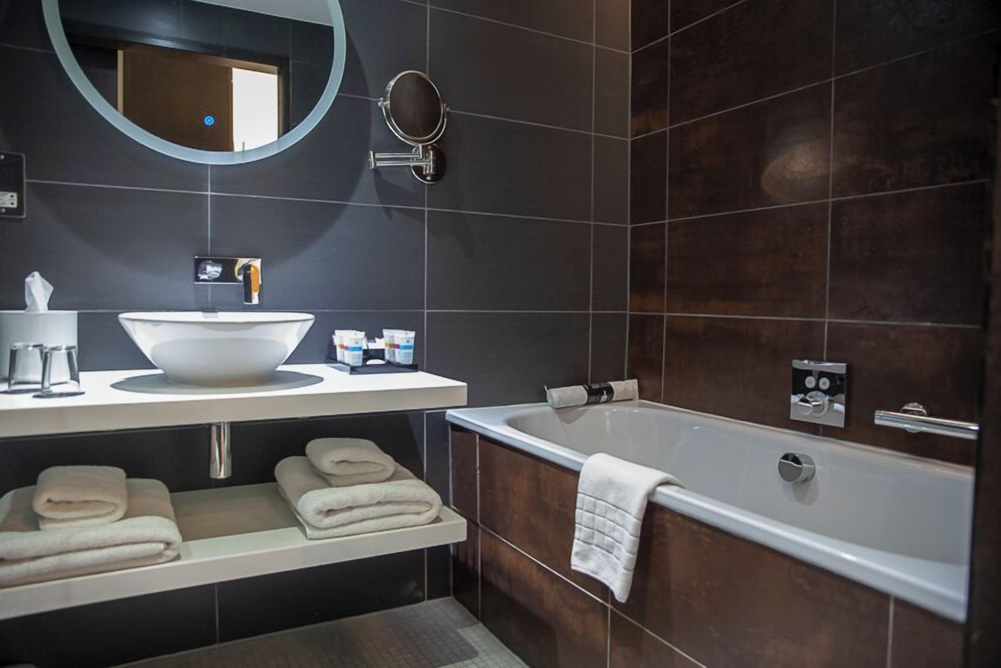 deluxe room, 1 king bed (premium) | bathroom | shower, rainfall showerhead, designer toiletries, hair dryer