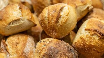 A basket filled with various types of bread.