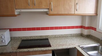 Full-sized fridge, microwave, stovetop, cookware/dishes/utensils