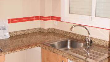 Full-sized fridge, microwave, stovetop, cookware/dishes/utensils