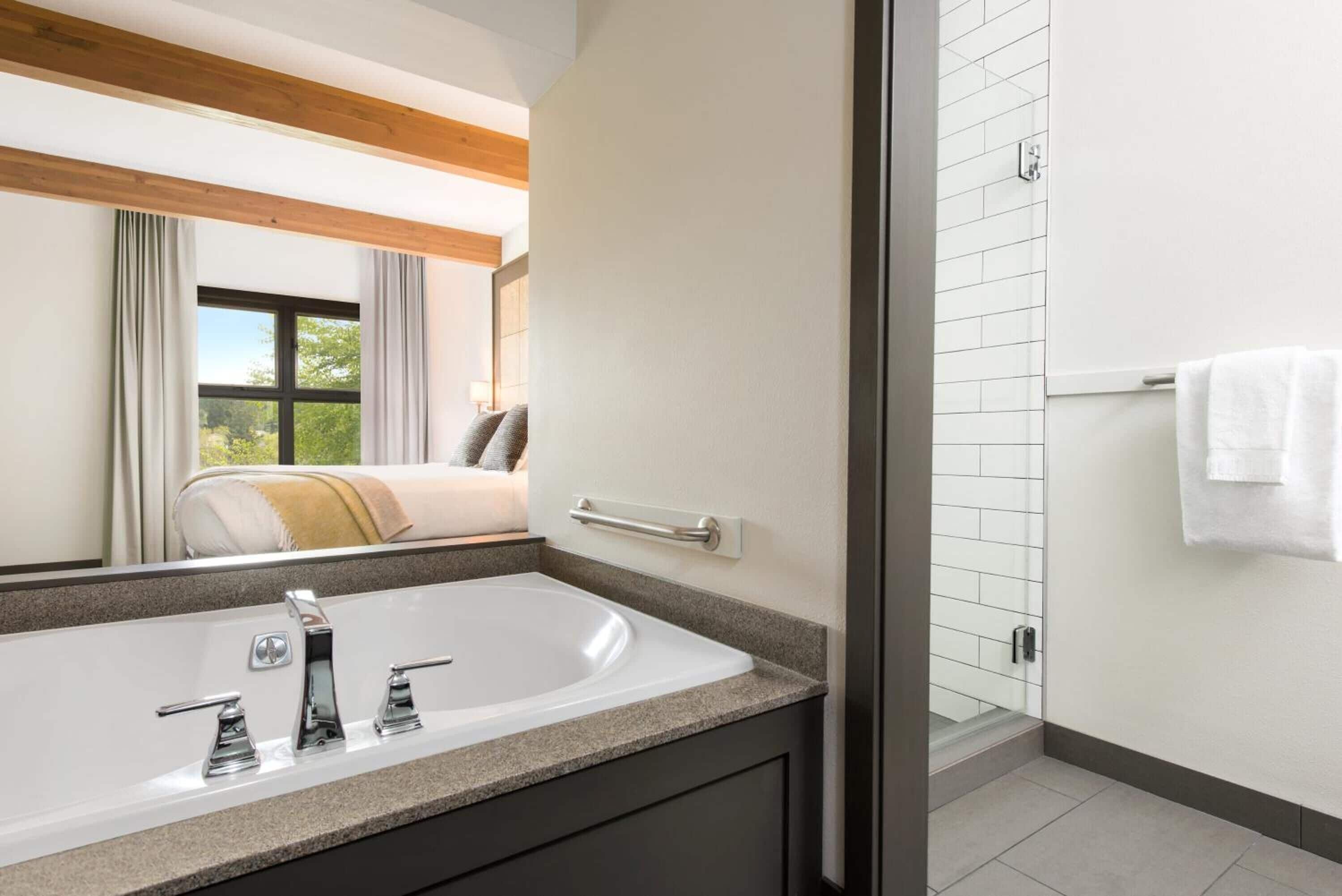 deluxe room, 1 king bed | bathroom | separate bathtub and shower, jetted bath, rainfall showerhead