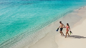 A beach with clear turquoise water and a sandy shore. - Secrets Akumal Riviera Maya - Adults Only - All Inclusive (Akumal)