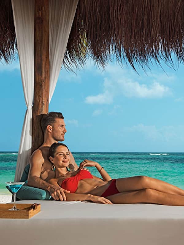 On the beach, white sand, beach cabanas, sun loungers