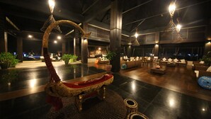 A spacious lobby with a central seating area featuring a unique, ornate chair and a modern sofa set. - Eskala Hotels & Resorts Ngwe Saung (Ngwe Saung)