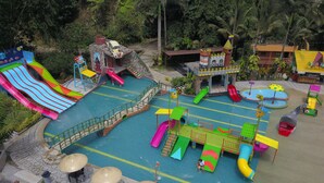 A water park with multiple slides and a castle-like structure.