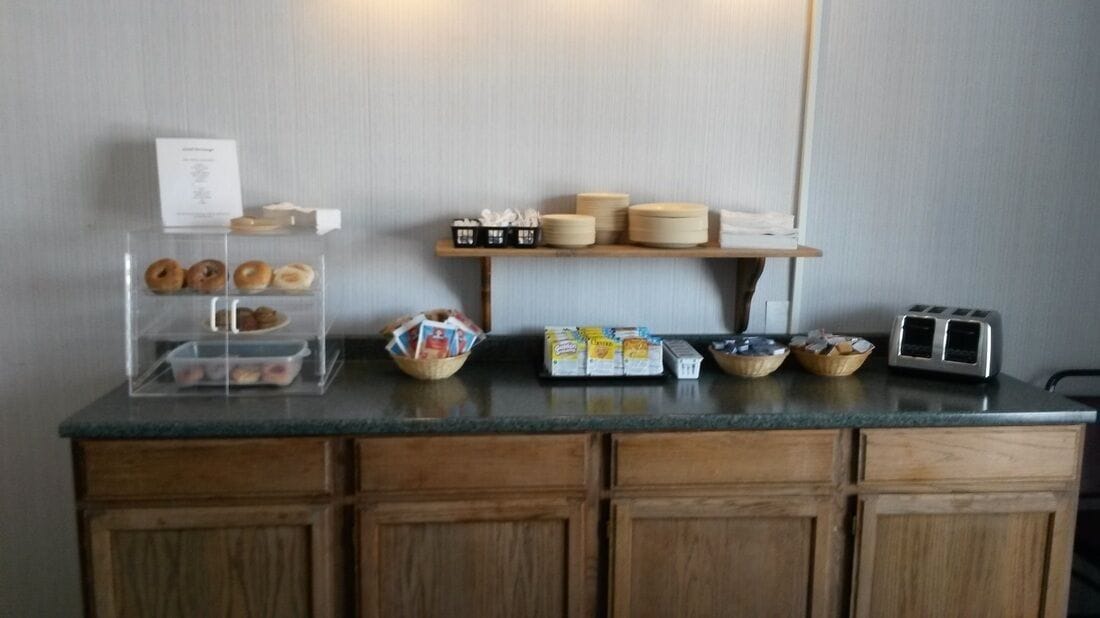 A kitchen counter with various food items and kitchenware.