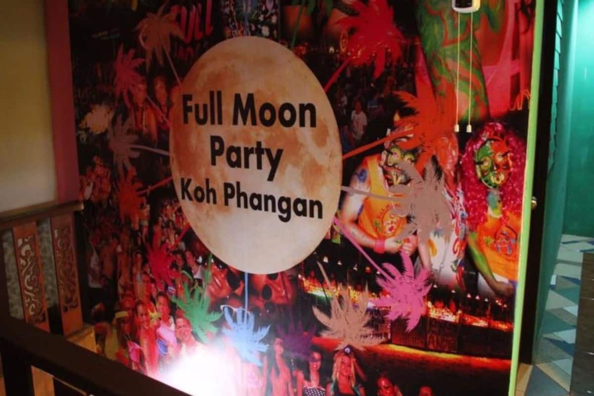 A colorful mural with a sign that reads "Full Moon Party Koh Phangan".