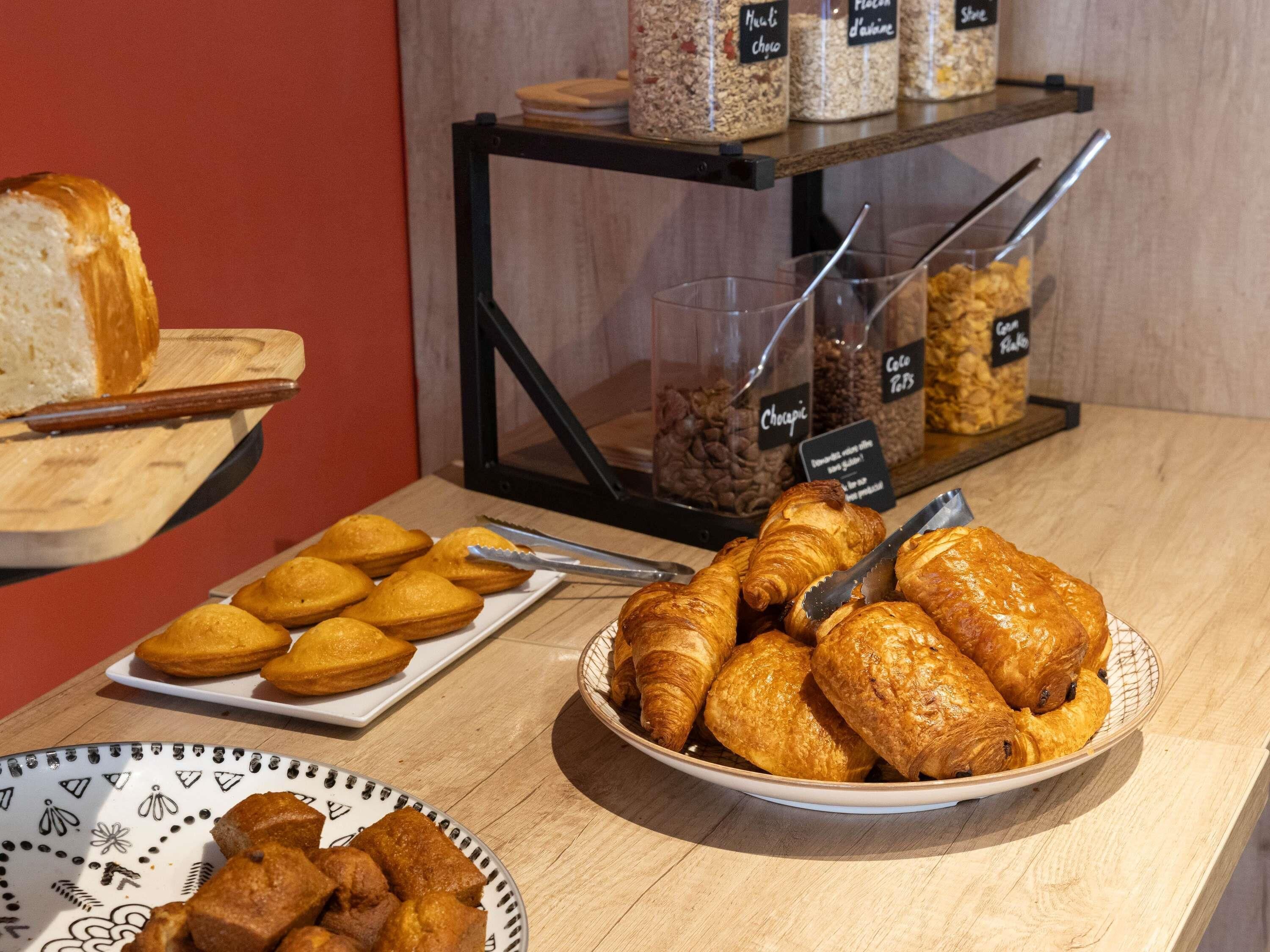 A display of pastries and bread in a bakery setting.