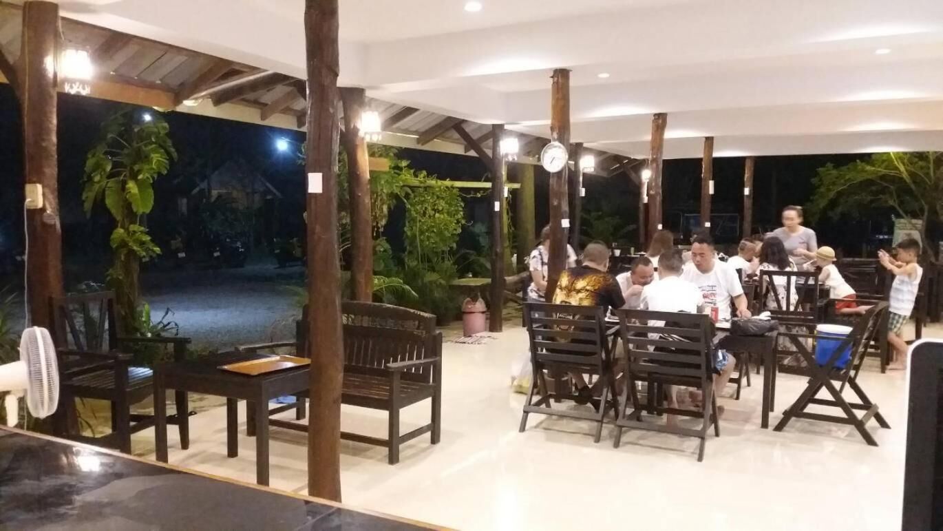 An indoor dining area with wooden furniture and a view of the outdoors.
