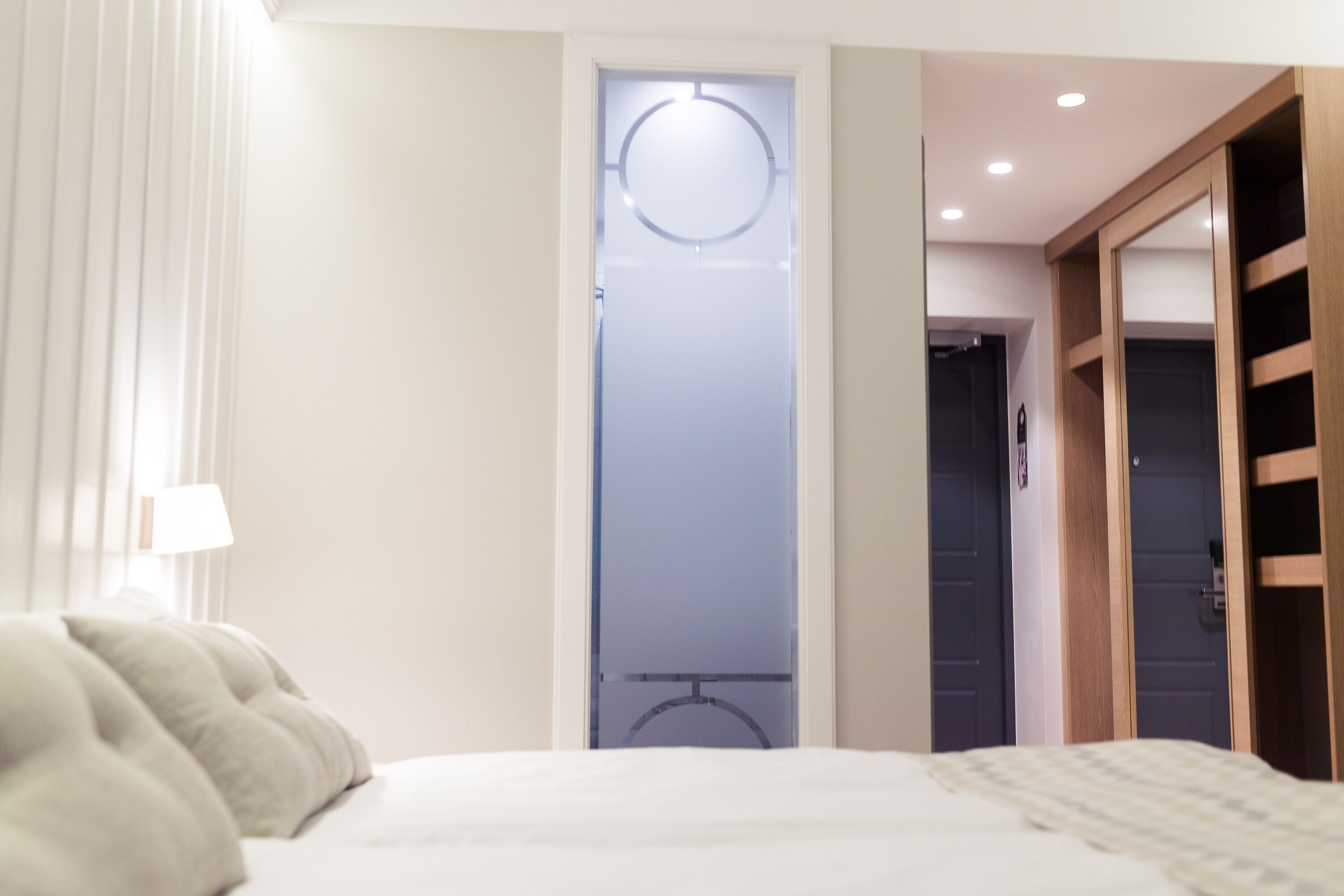 Una camera d'albergo con un letto, un armadio e un bagno.