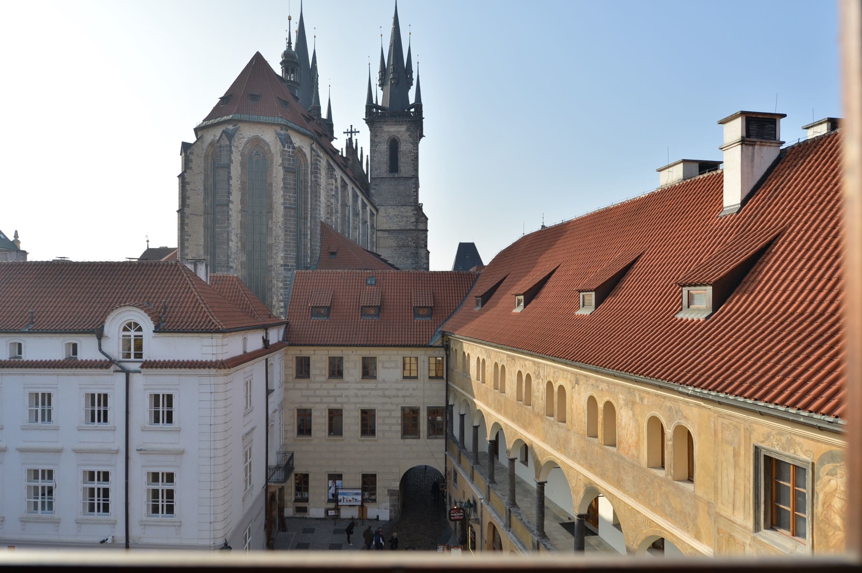 A historic building with a prominent tower and arched windows.