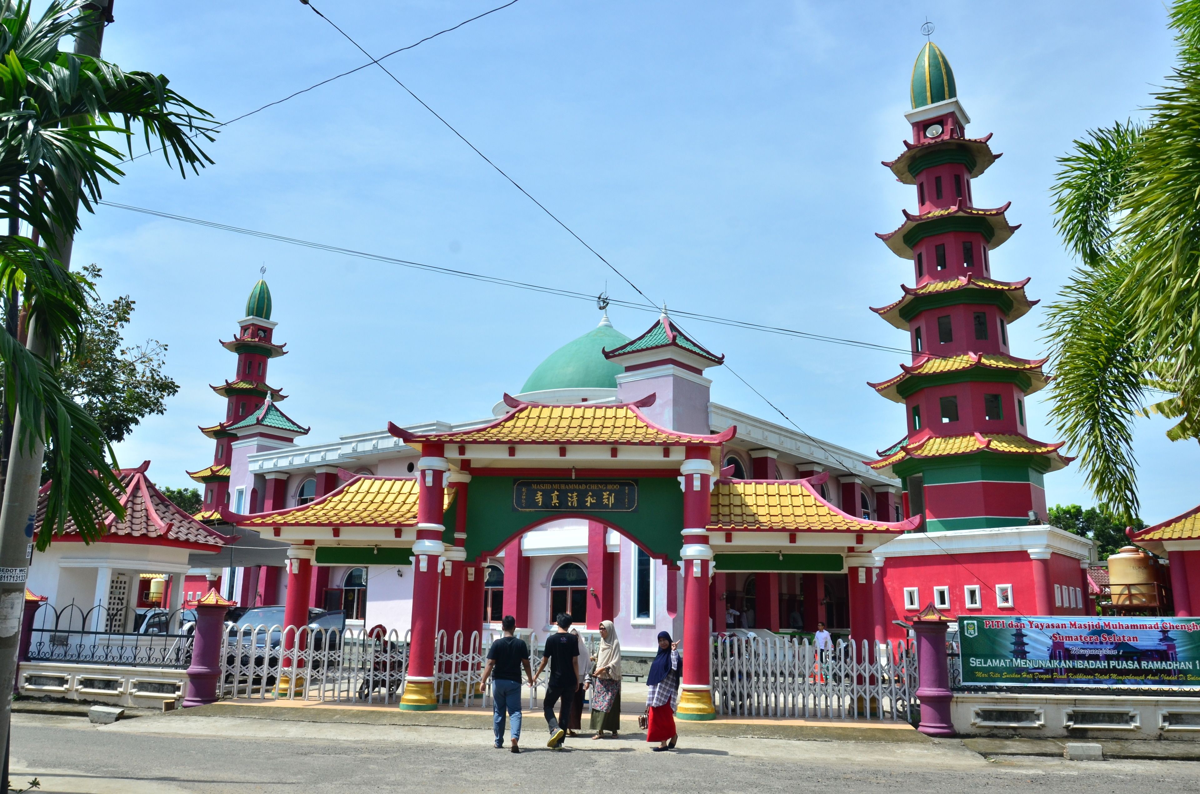 A multi-tiered pagoda-style building with a green dome and red and yellow roof.