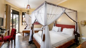 A room with a four-poster bed, a desk with a chair, and a television. - 2 Friends Beach Hotel (Entebbe)