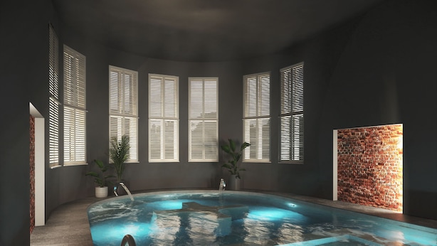 A swimming pool with a metal ladder, large windows with blinds, and a brick wall. - Hedon SPA & Hotel (Parnu)