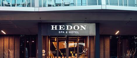 A modern building with a sign reading "HEDON SPA & HOTEL".