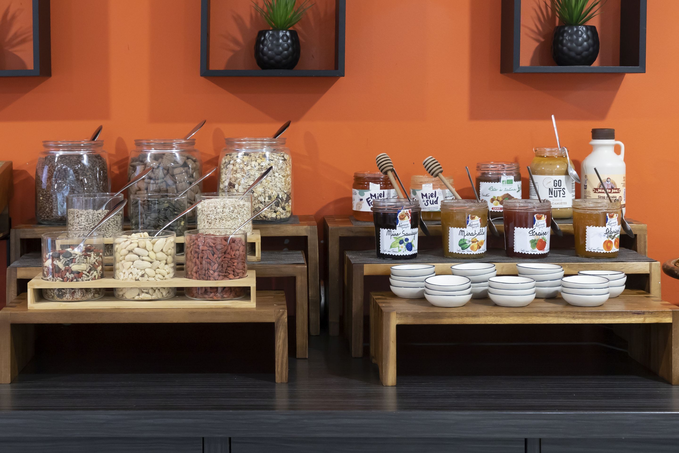 A buffet setup with various food items and condiments.