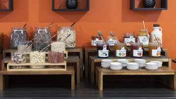 A buffet setup with various food items and condiments.