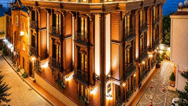 A multi-story hotel with a classic architectural style, featuring balconies and large windows.