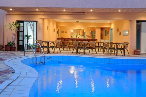 A pool area with a bar and seating.