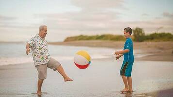 Guests can enjoy a game of beach volleyball on the sandy shore.