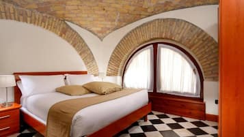 Un dormitorio con suelo a cuadros, una cama de madera, una mesita de noche y un ventanal con cortinas.