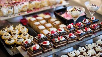 A variety of desserts on display, including cakes and pastries.
