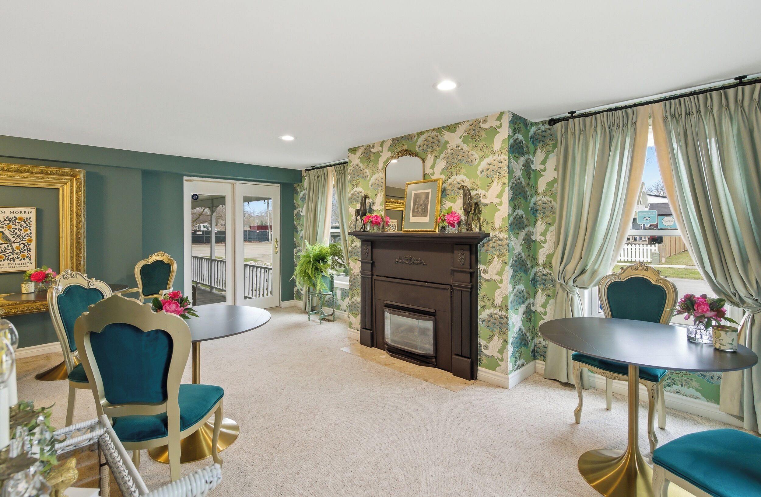 A room with a fireplace, a round table, and two chairs.