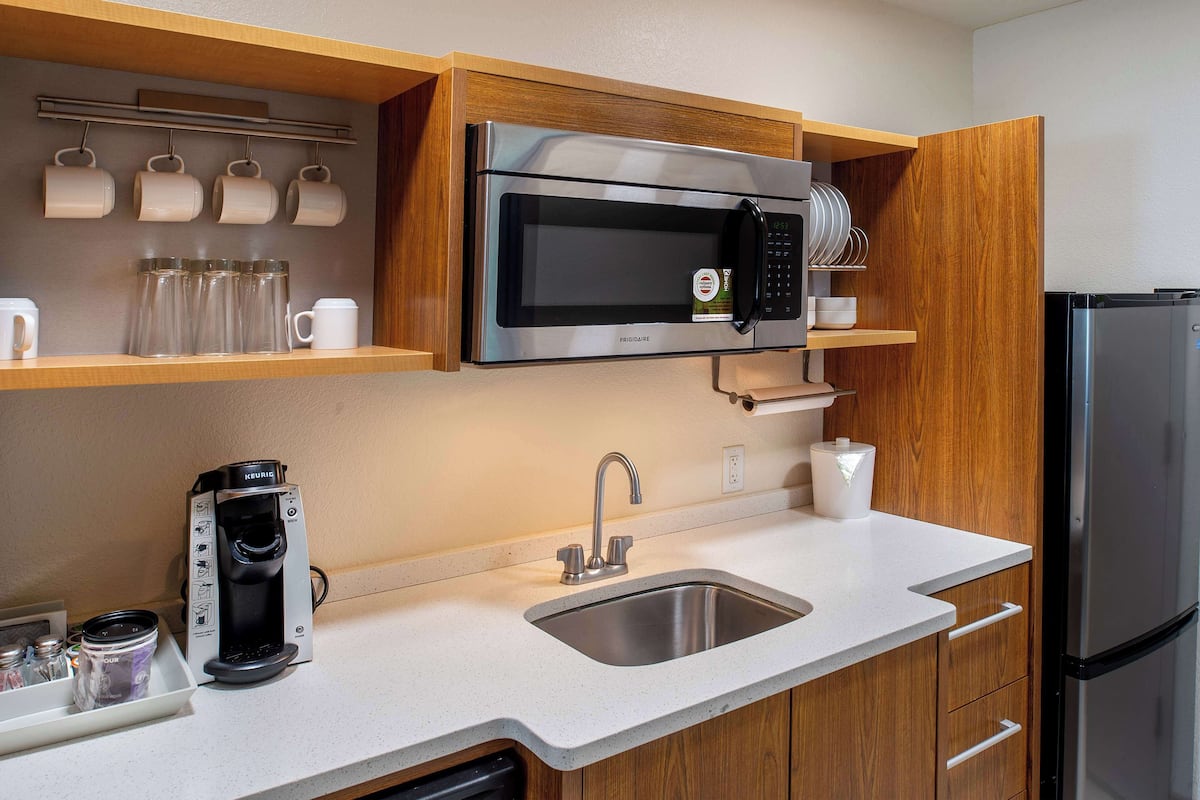 full-sized fridge, microwave, dishwasher, cookware/dishes/utensils