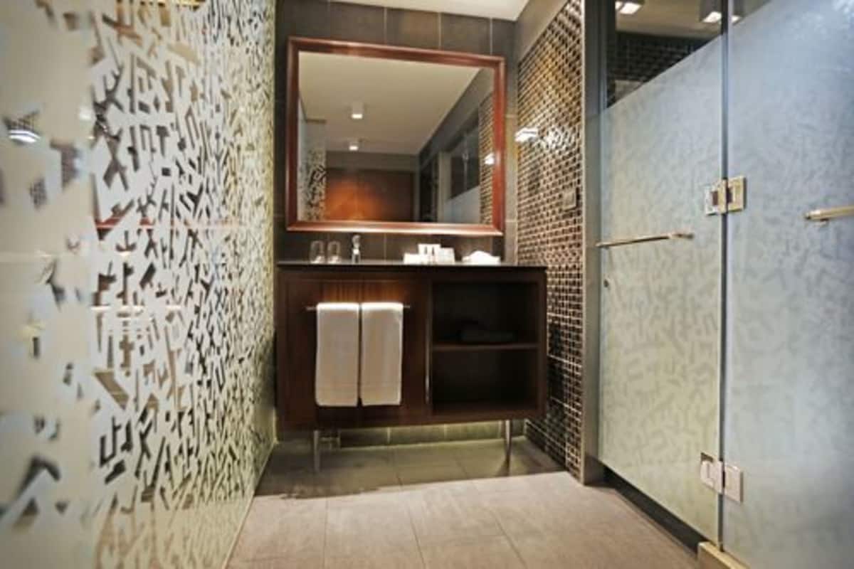 shower, hair dryer, slippers, towels