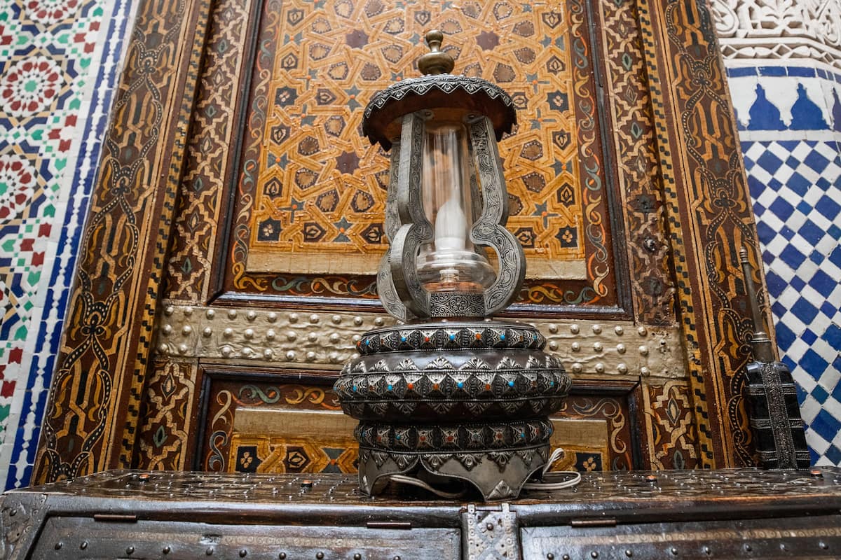 An ornate wooden cabinet with intricate carvings and a decorative metal fixture.