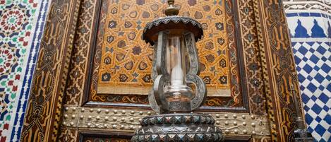 An ornate wooden cabinet with intricate carvings and a decorative metal fixture.