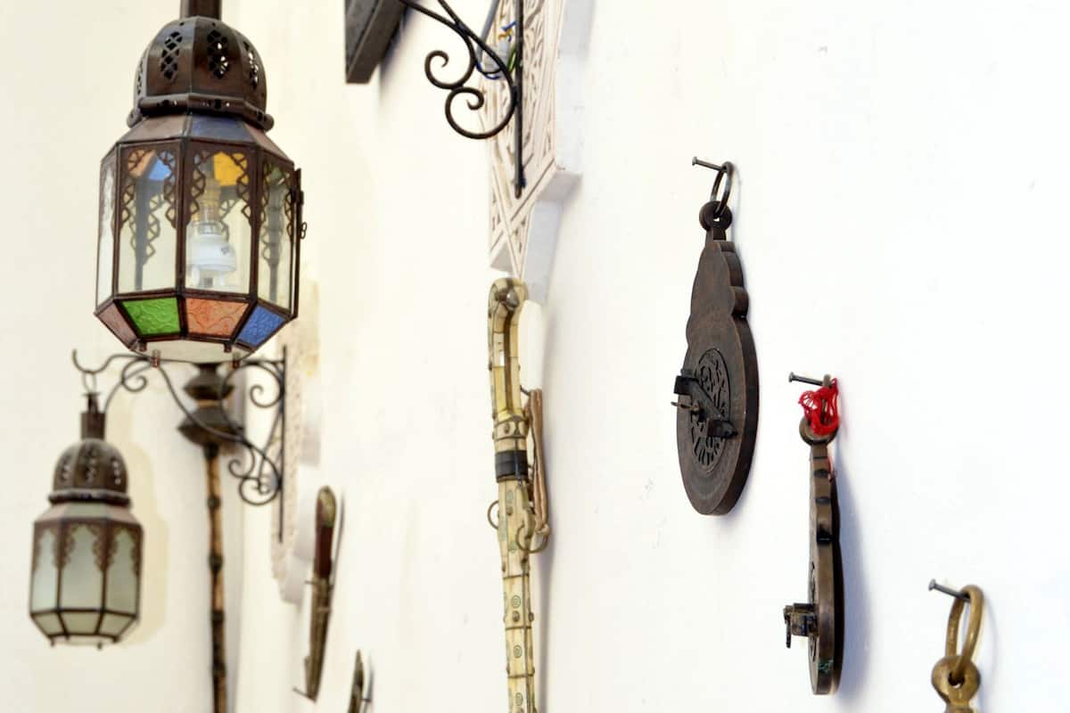 A wall with various historical artifacts, including a lantern, a sword, and other weapons.