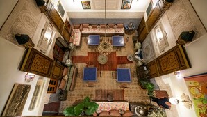 A room with a central seating area, patterned walls, and traditional decor. - Riad Dar Tahri & SPA (Fes)