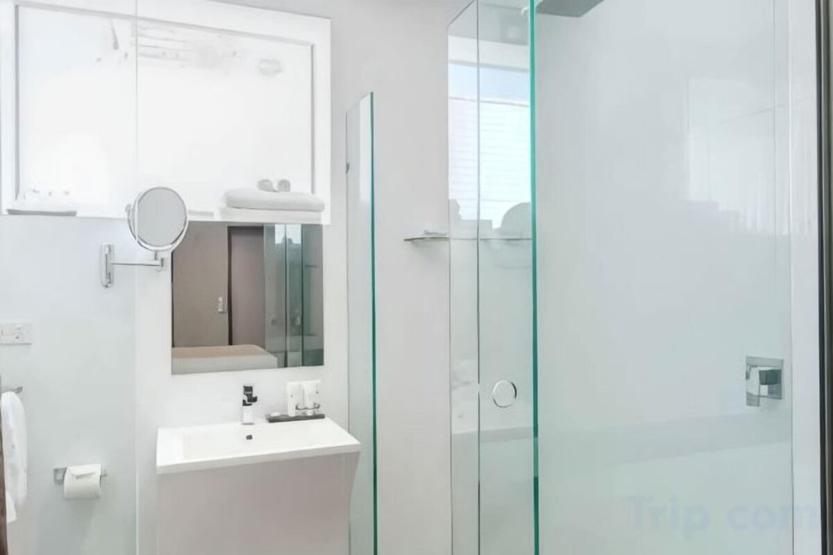 Shower, designer toiletries, hair dryer, towels