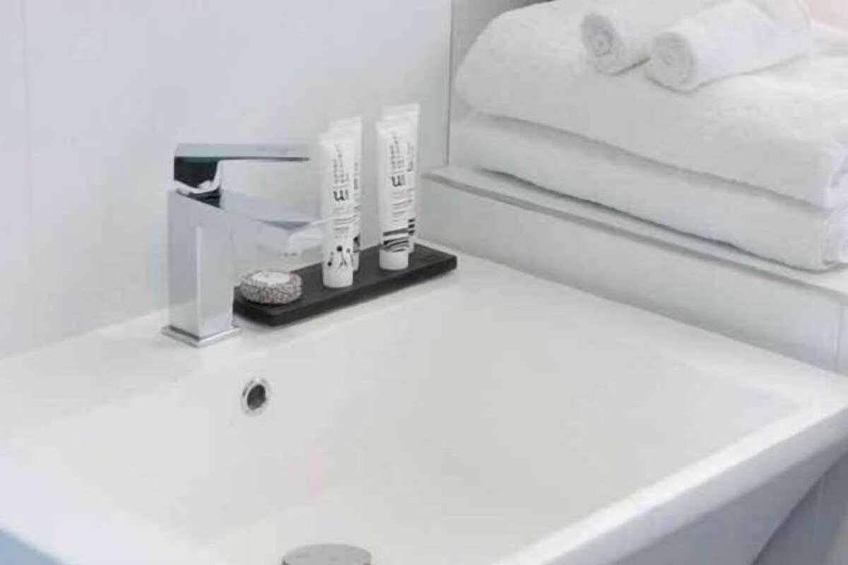 Shower, designer toiletries, hair dryer, towels