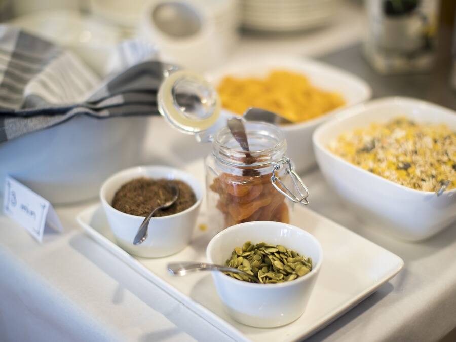 A breakfast buffet with various food items and condiments.