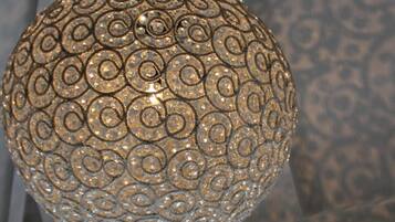 A spherical pendant light with a detailed, embossed pattern.