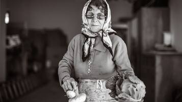 A person holding a bulb and a headscarf.